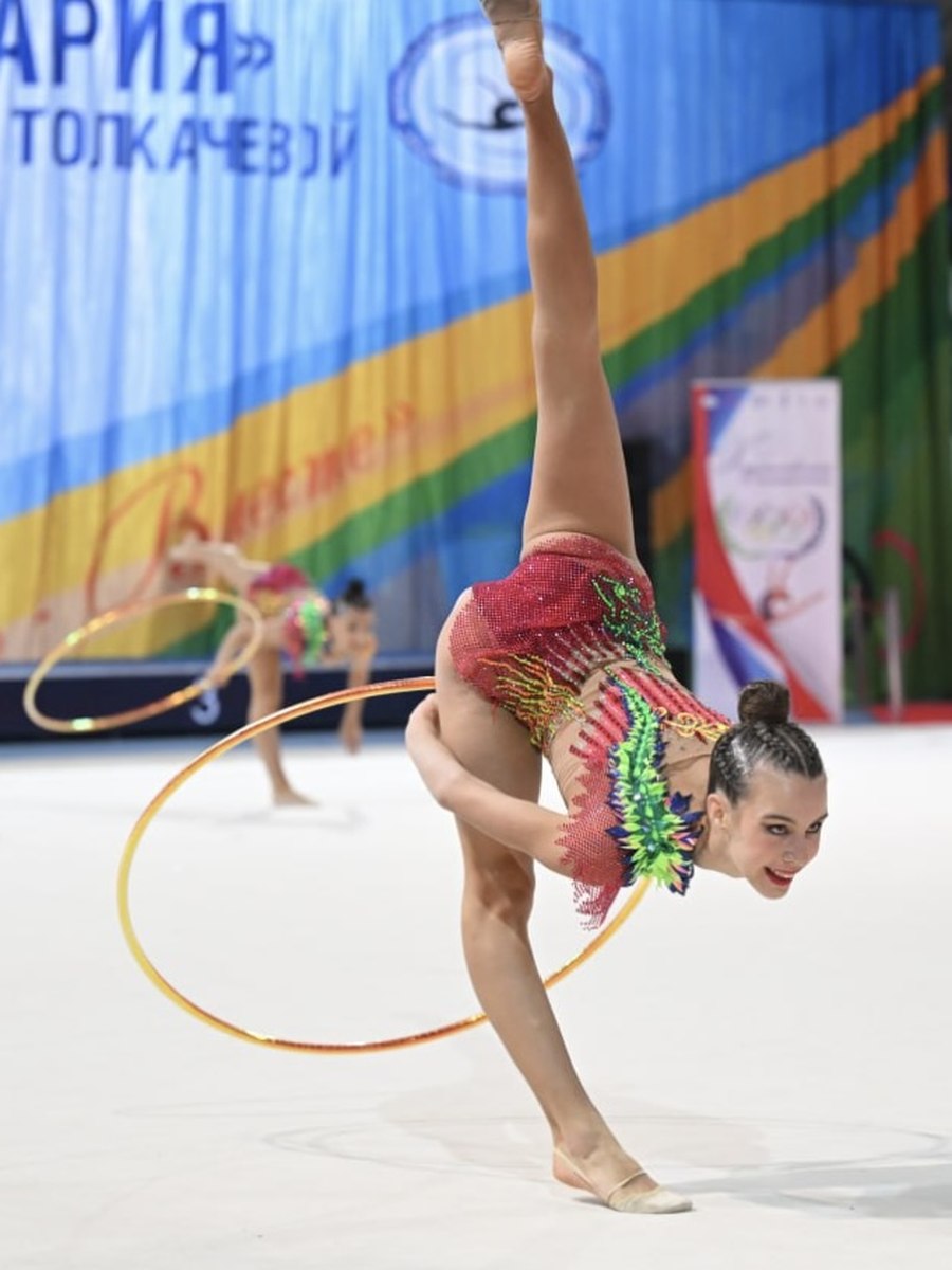 Mariia Miroshnik performing a backbend with a hoop during a competition