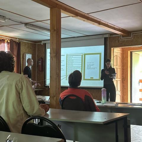 Mariia Miroshnik presenting the project findings on screen to the research group